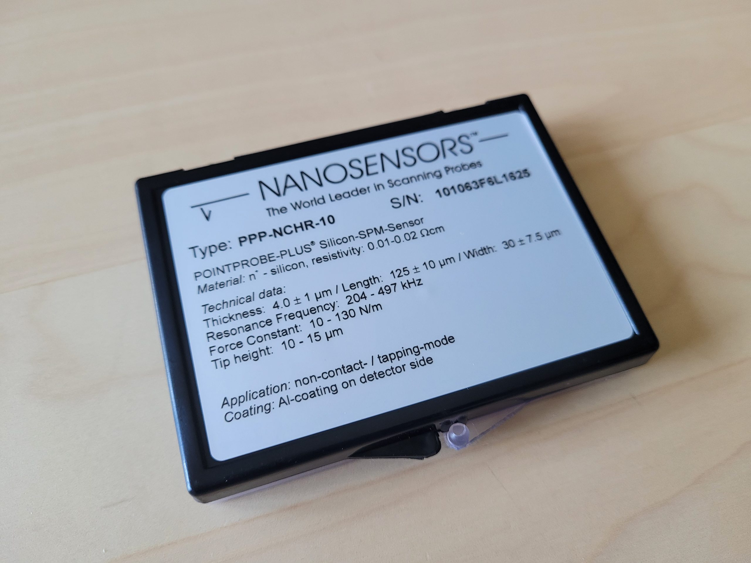 Current packaging label for a NANOSENSORS AFM probe showing the specified resonant frequency and force constant ranges.